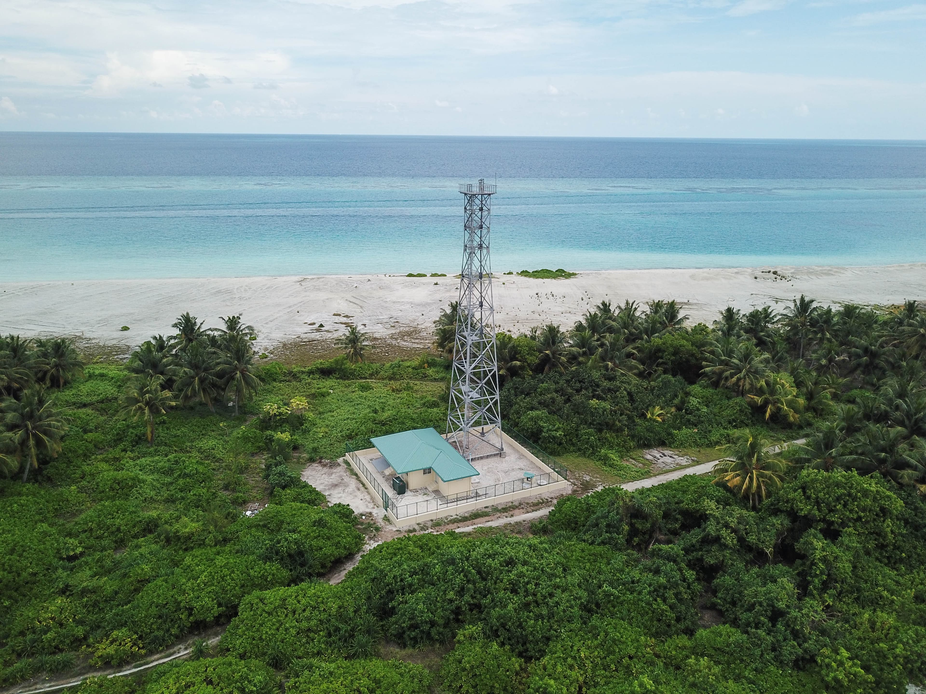 Aerial view of a coastal surveillance tower on a Maldivian beach