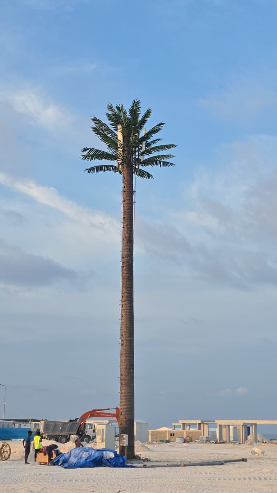 Camouflaged palm tower under construction on a reclamation site