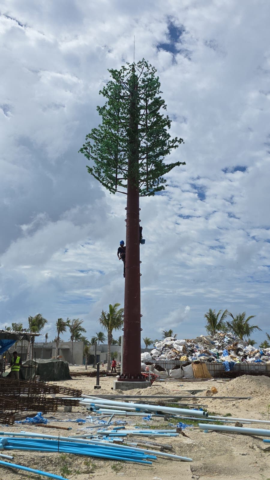 Pine-camouflaged telecom tower during erection