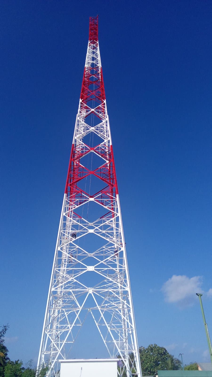 Freshly painted red-and-white lattice telecom tower