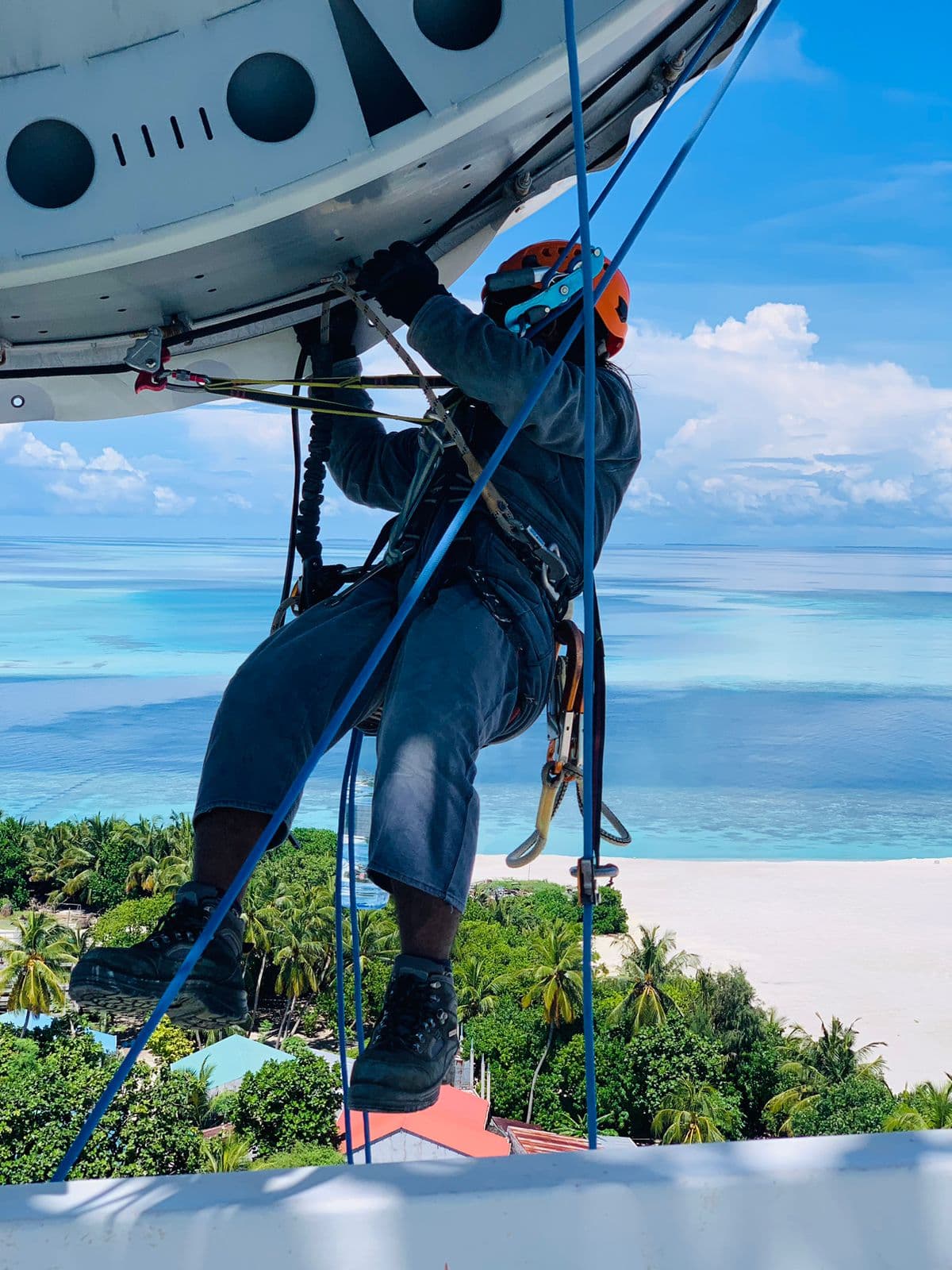 Rishthaa technician working atop a microwave dish