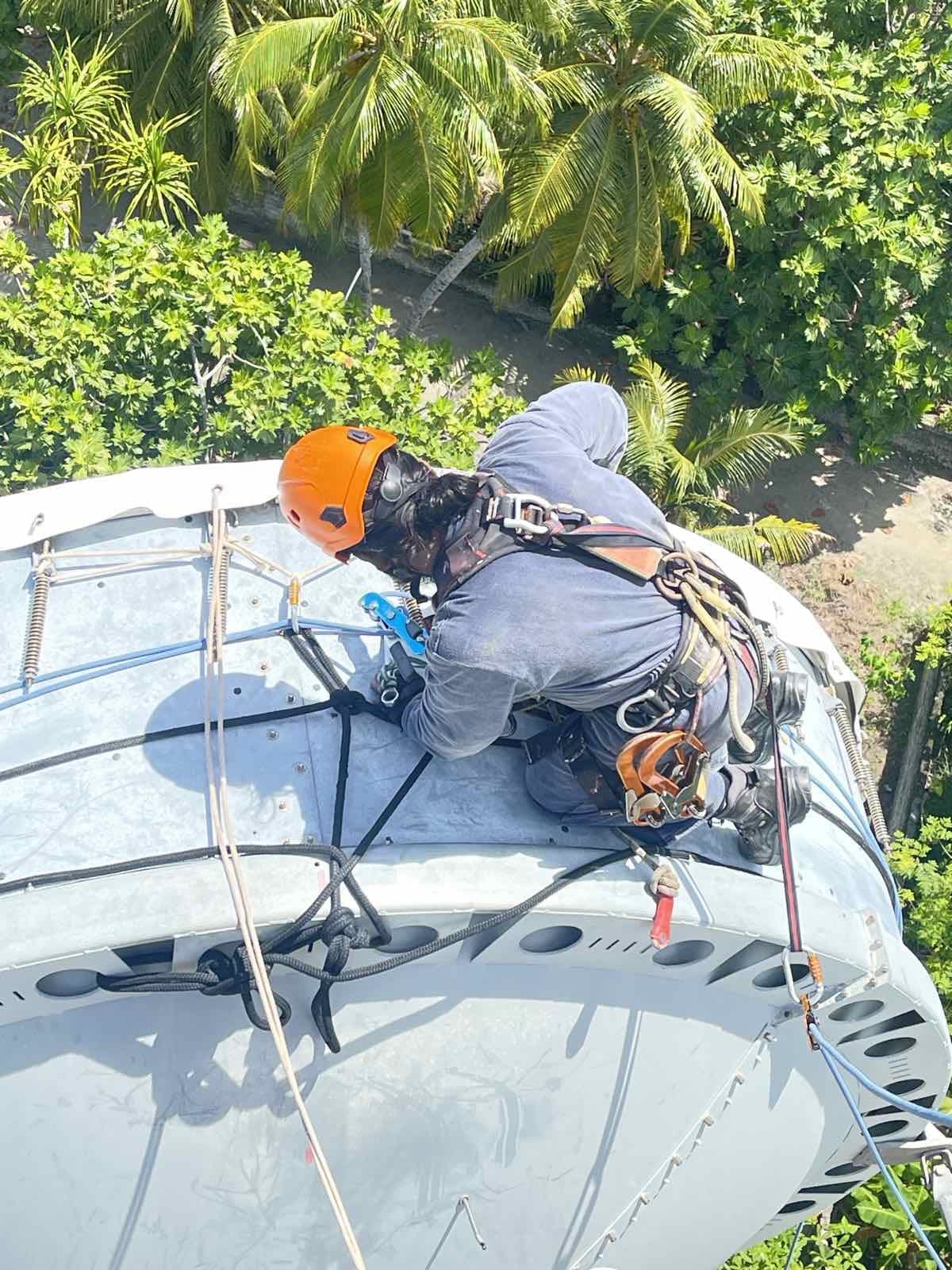 Rishthaa rope-access technician at a microwave dish