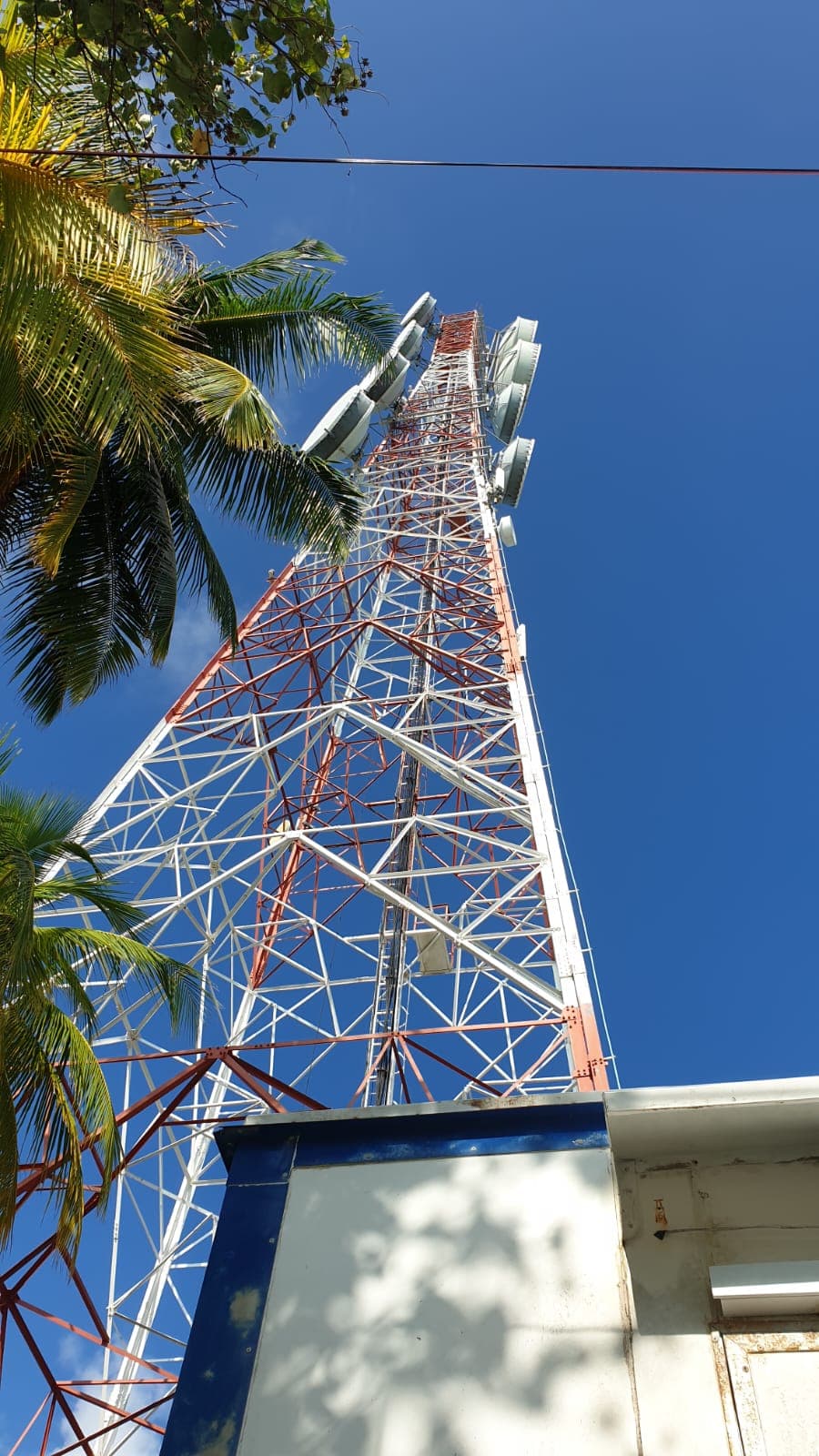 Lattice telecom tower against a blue sky