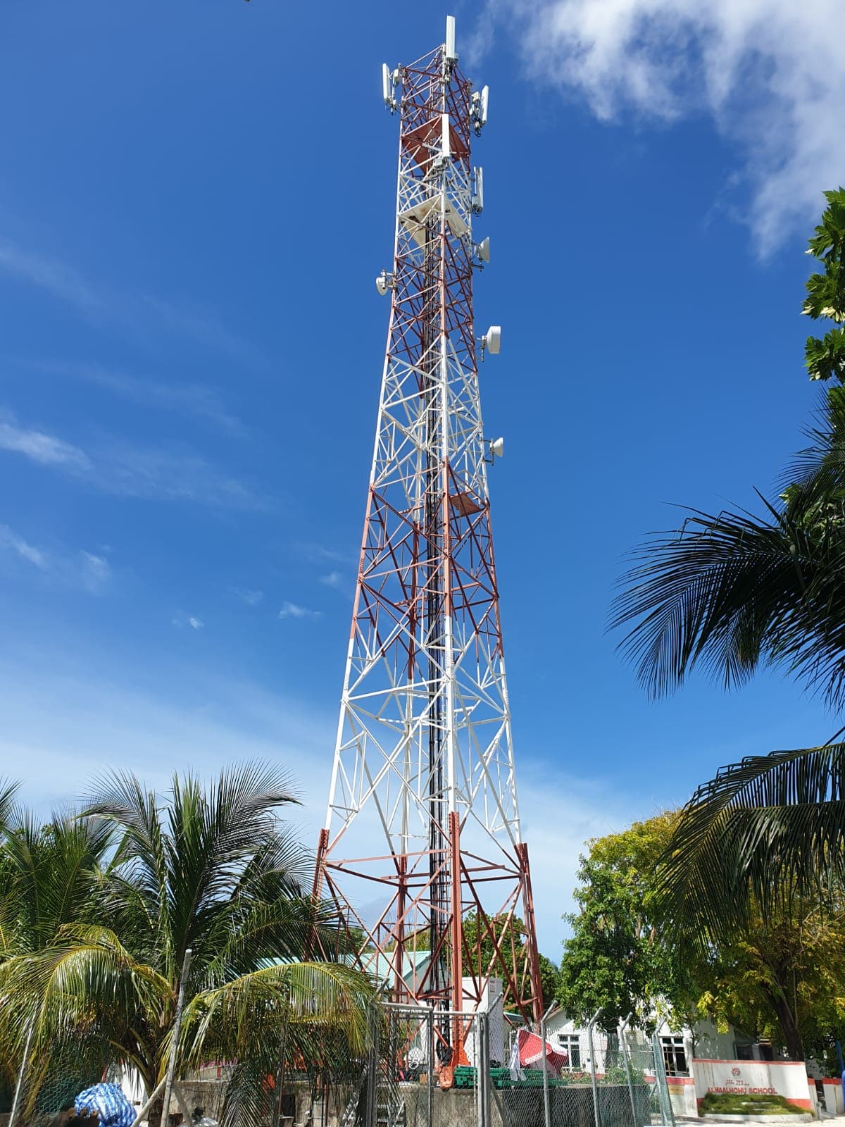 Lattice telecom tower beside a Maldivian school