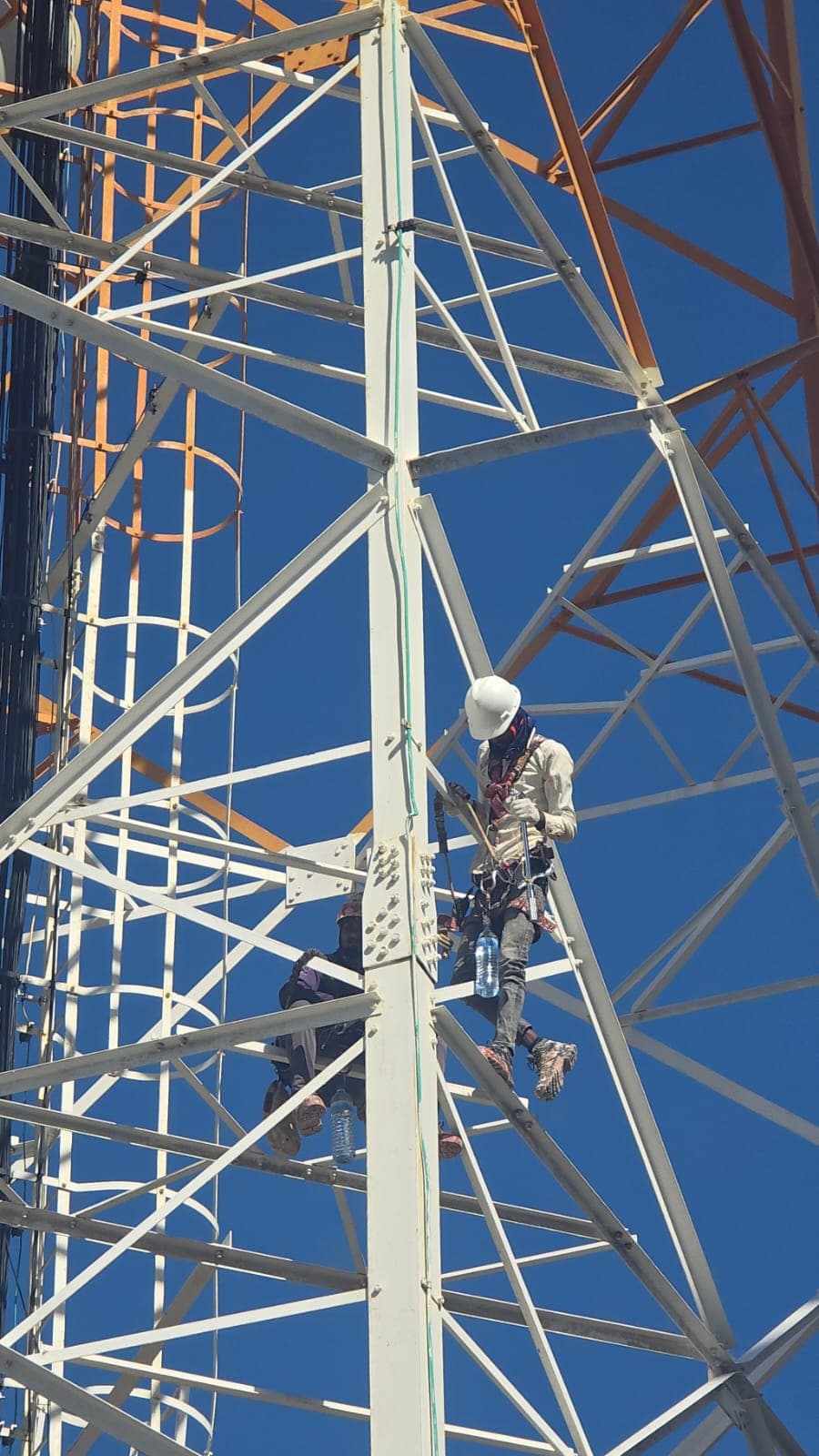Rishthaa crew working inside a lattice tower structure