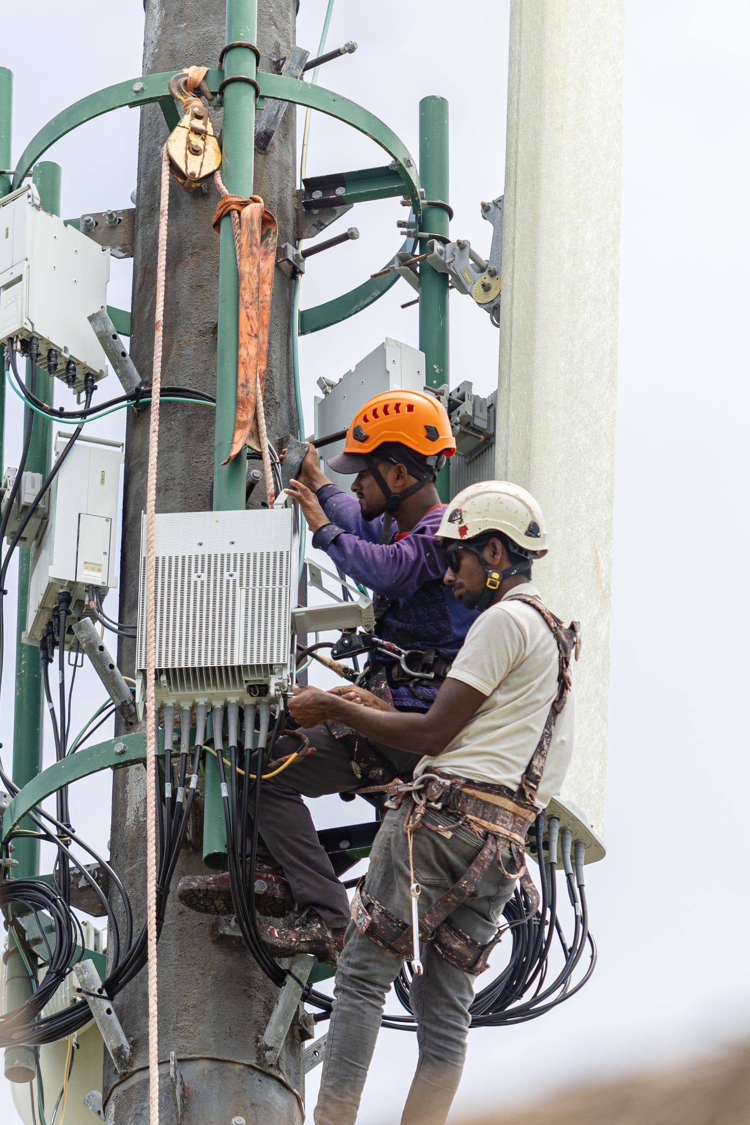 Rishthaa technicians wiring telecom tower equipment